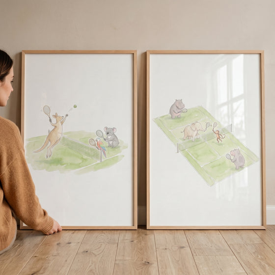 Framed soft watercolor tennis animals artwork set of 2 with a kangaroo, hippo, elephant, and monkey on green courts.
