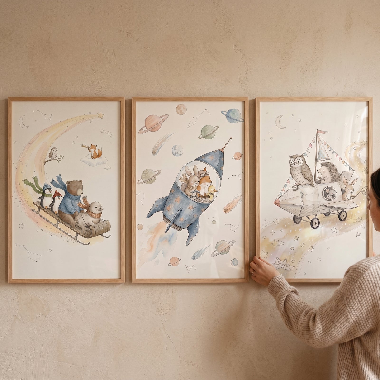 Soft watercolor whimsical animals artwork set of 3 featuring cute creatures in a rocket, plane, and on a moon sledge.