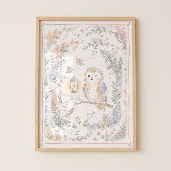 Soft watercolor winking owl wall art in a light wood frame featuring a cute bird with a lantern and floral illustrations.