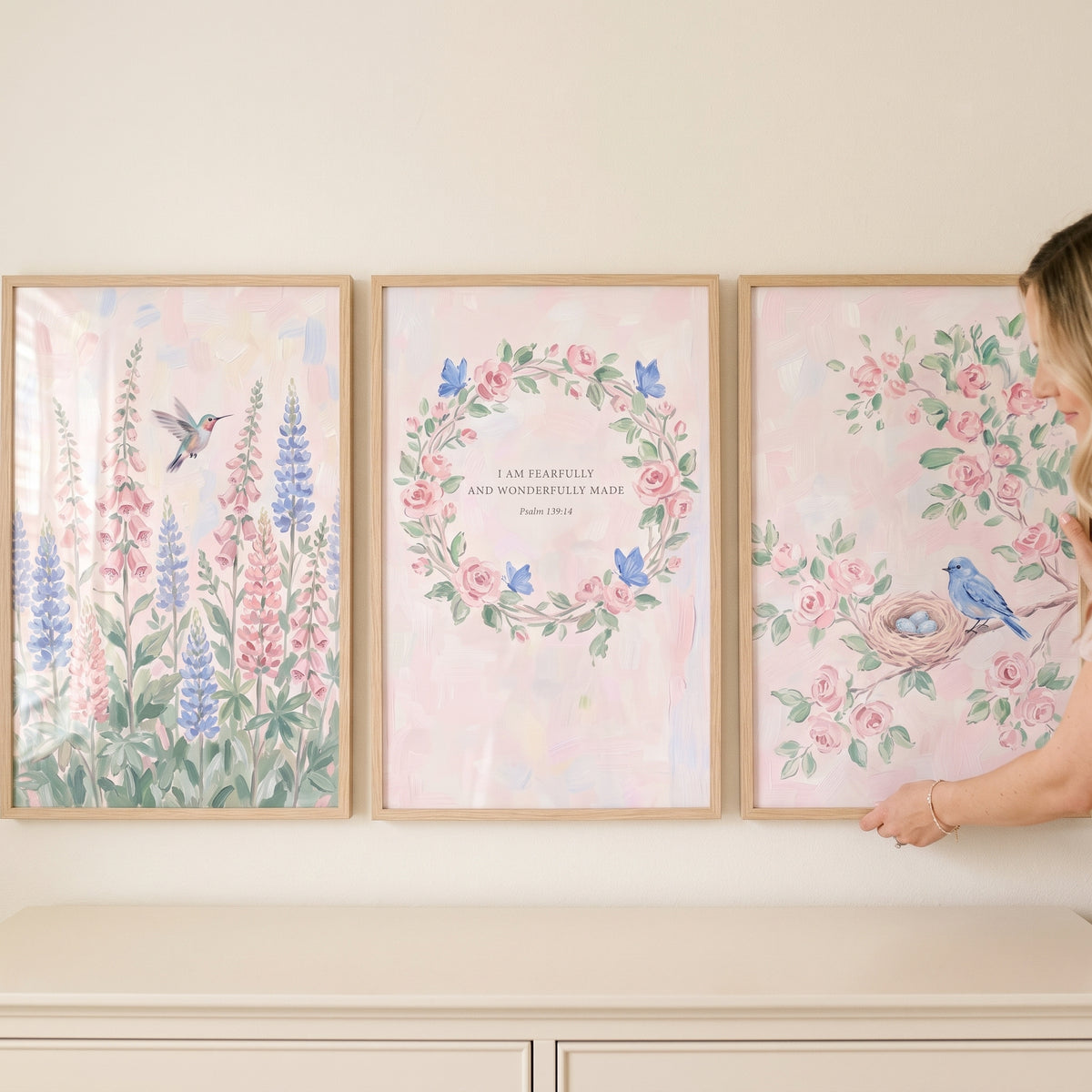 Soft wildflower meadow wall art set of 3 featuring birds and pink floral designs in light wood frames.