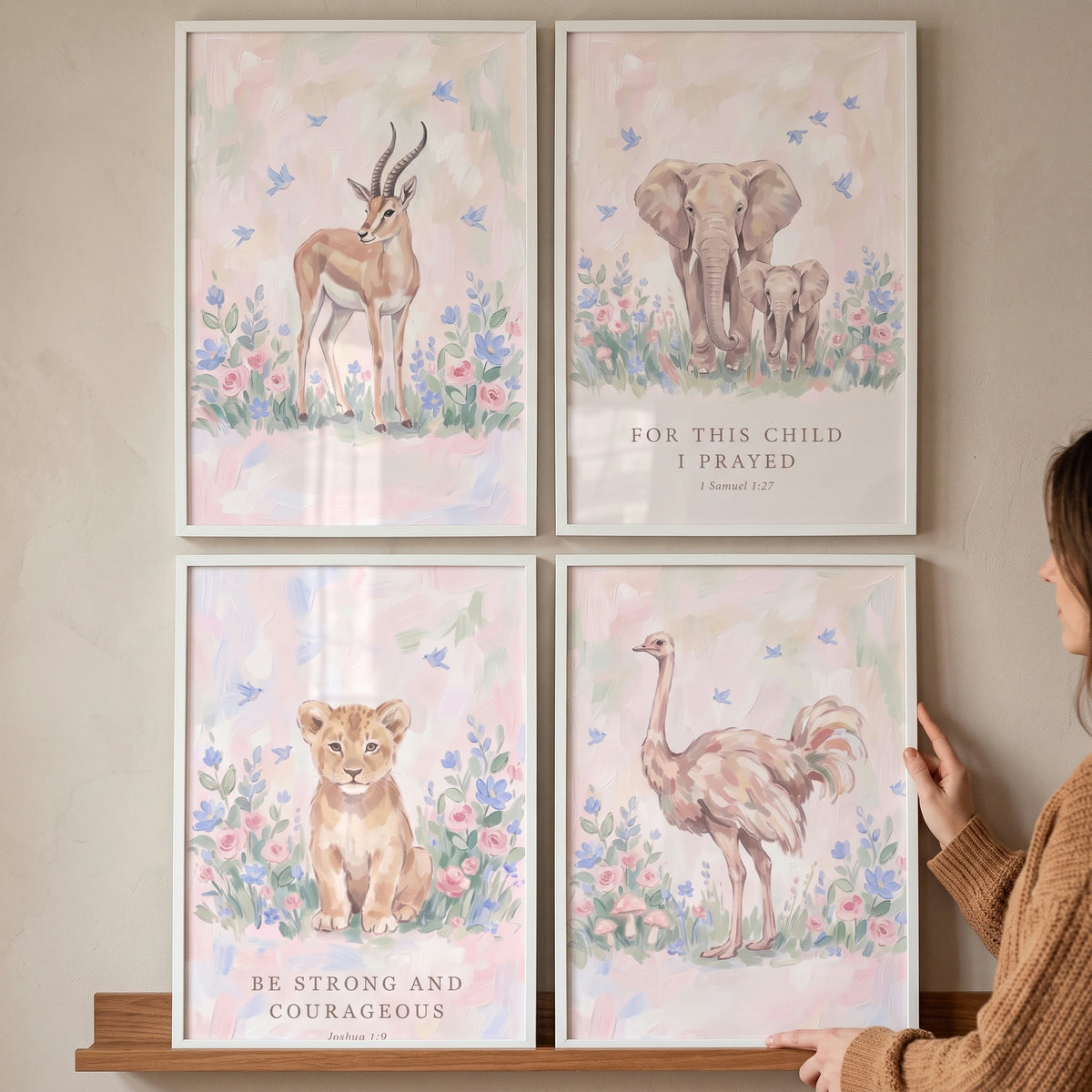 Soft wildflower savanna animals artwork set of 4 featuring a gazelle, elephant, lion cub, and ostrich with nursery text.