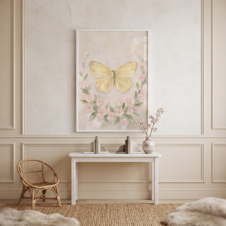 Soft yellow textured butterfly wall art above a white table with bookends and a vase, next to a rattan chair and jute rug.