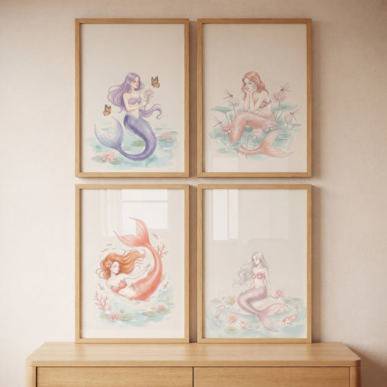 Sophisticated blush watercolor mermaid wall art set of 4 displayed in wooden frames on a wall above a dresser.
