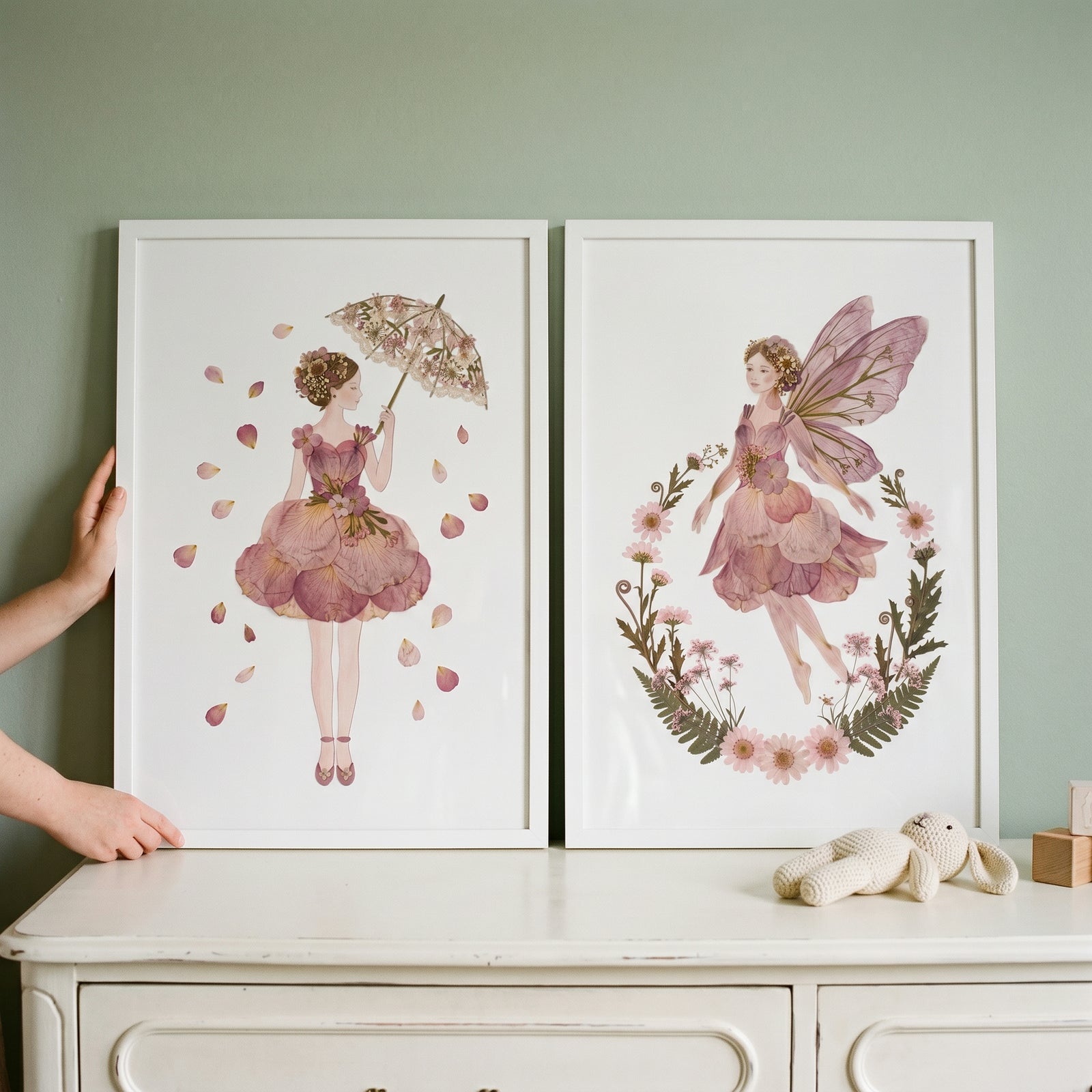 Sophisticated mauve botanical girl wall art set of 2 featuring floral figures in white frames on a white dresser.