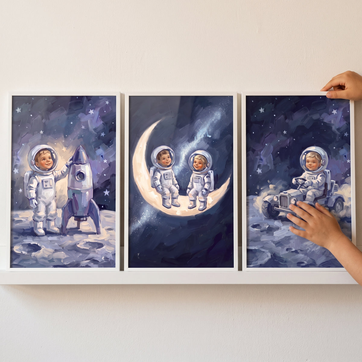 Sophisticated navy baby astronaut wall art set of 3 featuring a rocket, babies on a crescent moon, and a lunar rover.