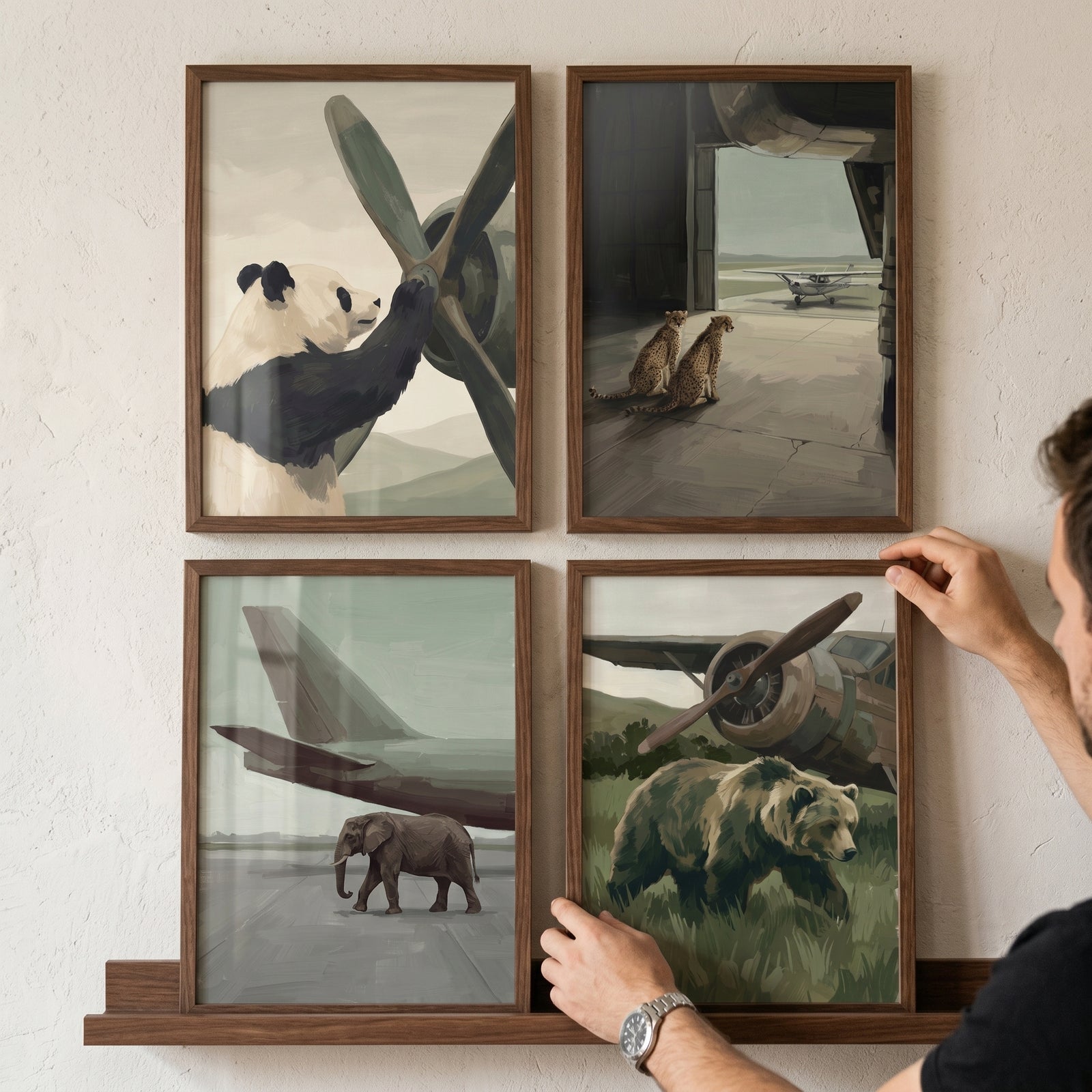Person hangs a sophisticated neutral aviation animal wall art set of 4 featuring a panda, cheetahs, elephant, and bear.