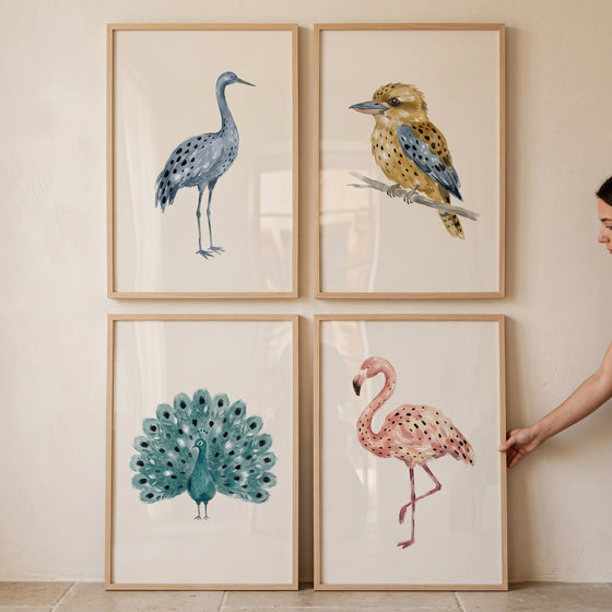 Sophisticated neutral watercolor birds wall art set of 4 featuring a blue crane, kookaburra, peacock, and pink flamingo.