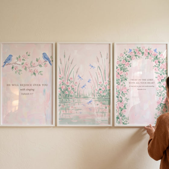 Sophisticated pink botanical garden wall art set of 3 with birds, dragonflies, and scripture in white frames.