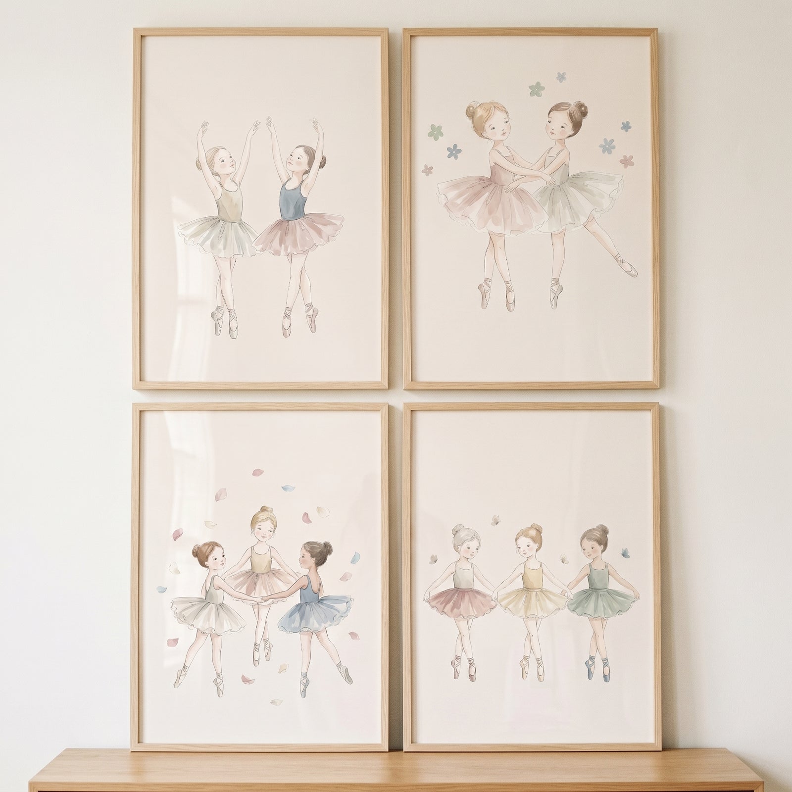 Sophisticated watercolor little ballerina wall art set of 4 in light wood frames displayed on a white wall.