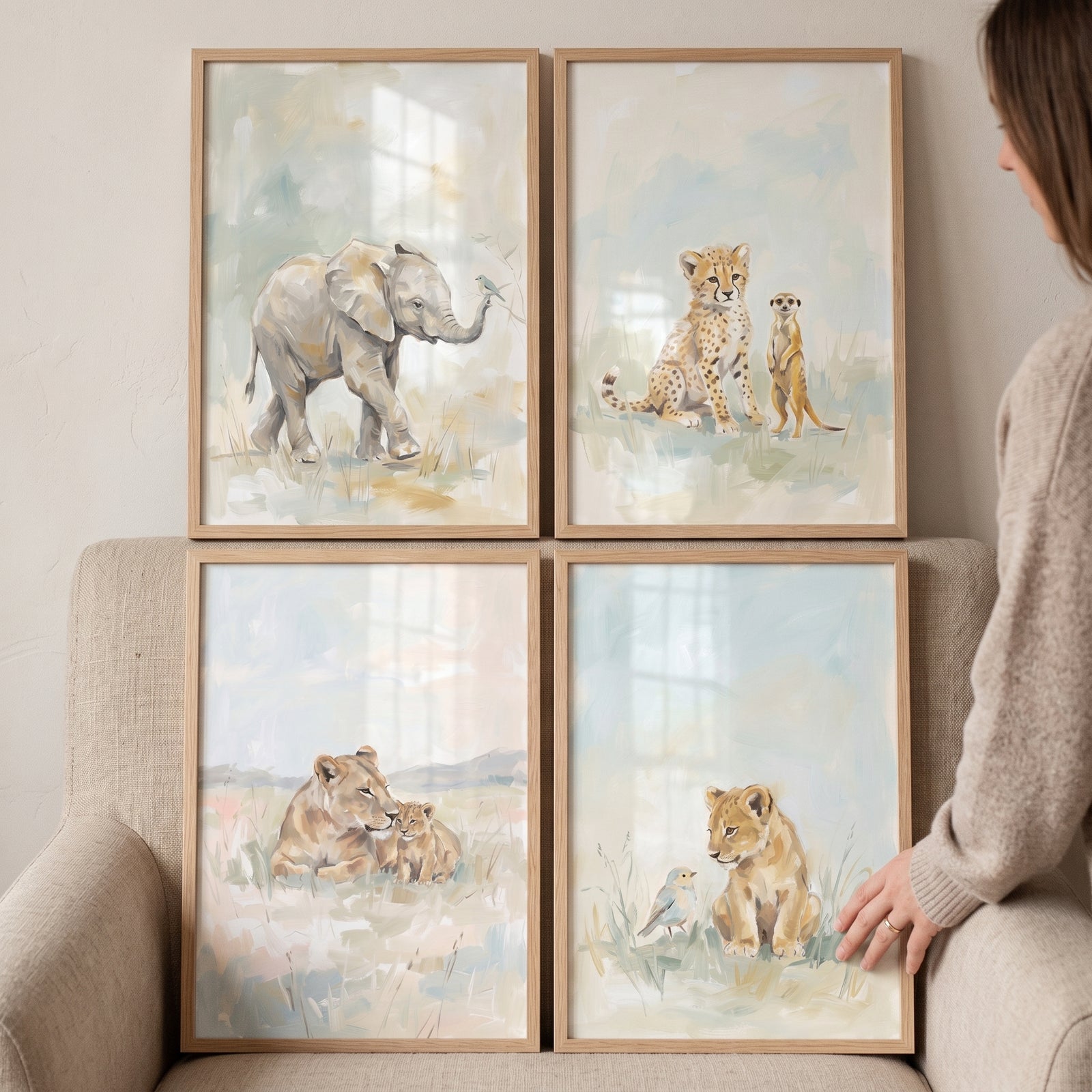 Sophisticated watercolor safari animals artwork set of 4 featuring an elephant, cheetah cub, and lions in wooden frames.