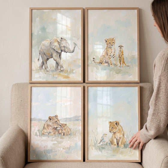Sophisticated watercolor safari animals artwork set of 4 featuring an elephant, cheetah cub, and lions in wooden frames.