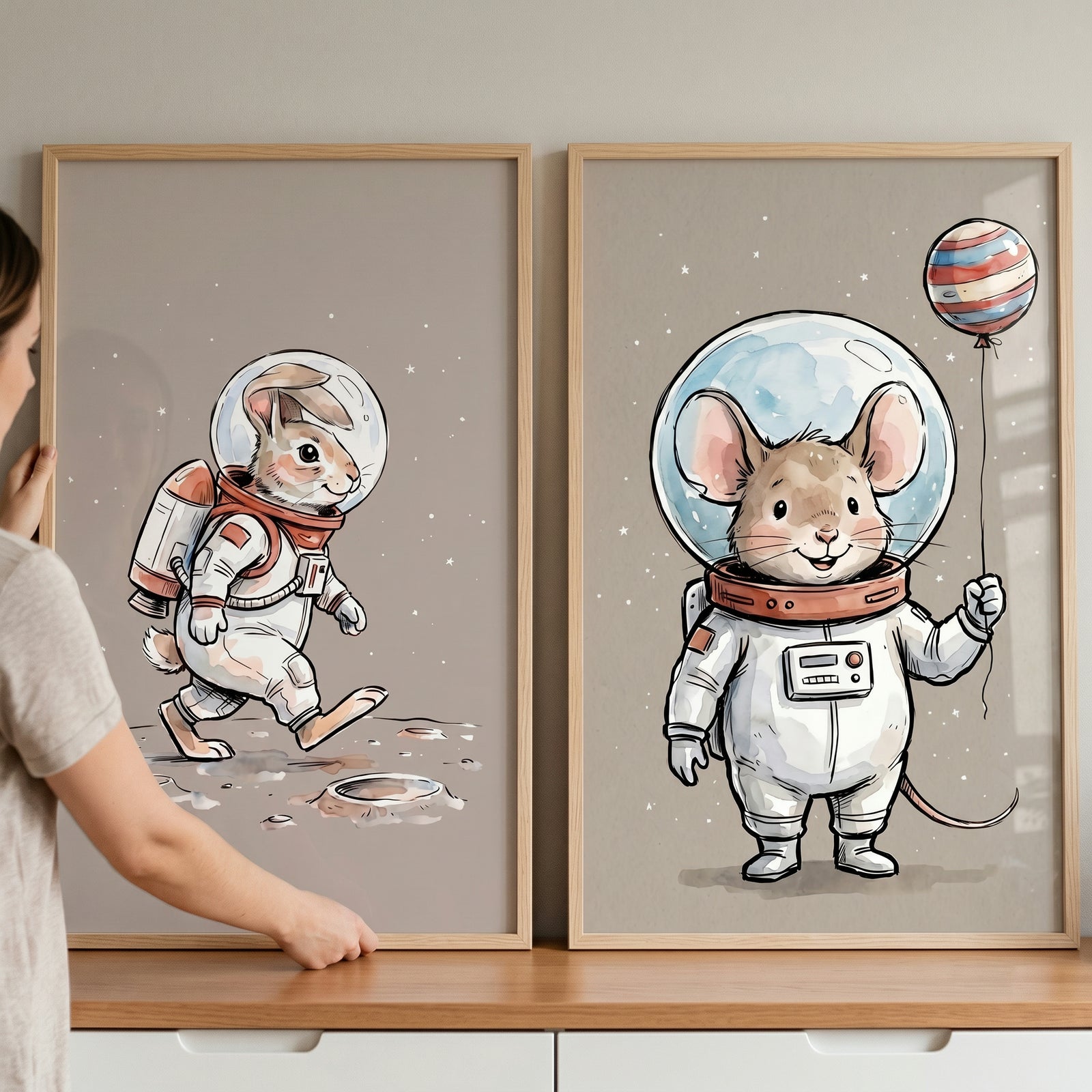 Framed space explorer animal wall art set of 2 with a rabbit on the moon and a mouse holding a planet balloon.