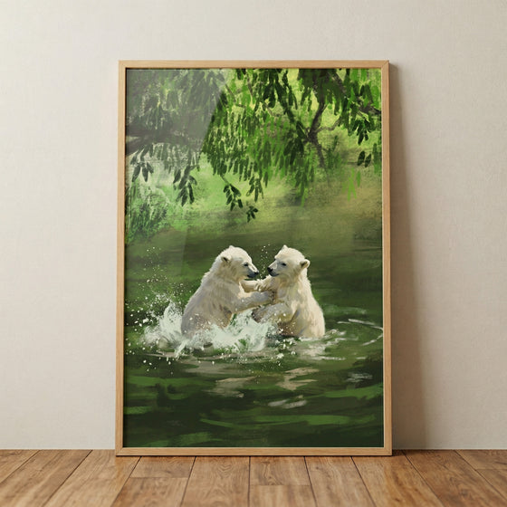 A framed digital illustration of two white polar bear cubs playing and splashing in a green forest pond. The cubs are in the center, surrounded by white water splashes. Lush green foliage hangs from above, reflecting in the dark green water. The artwork is in a light wood frame, positioned against a neutral wall on a wooden floor.