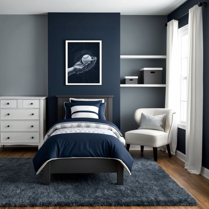 Contemporary bedroom featuring navy blue walls, white furniture, and bedding with blue and white accents. A framed art print above the bed showcases a detailed illustration of a hand holding a baseball, emphasizing a sporty theme. Natural lighting softly illuminates the room.