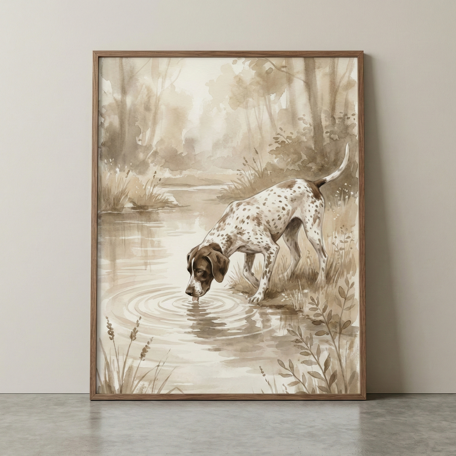 A sepia-toned watercolor illustration of a spotted dog, reminiscent of a hunting breed, leaning over to drink from a pond. Soft ripples emanate from its muzzle where it touches the water's surface. The scene is set in a peaceful natural environment with tall reeds in the foreground and a hazy forest in the background. The monochromatic brown palette creates a warm, vintage aesthetic. The artwork is presented in a simple wooden frame, resting against a neutral-colored wall.