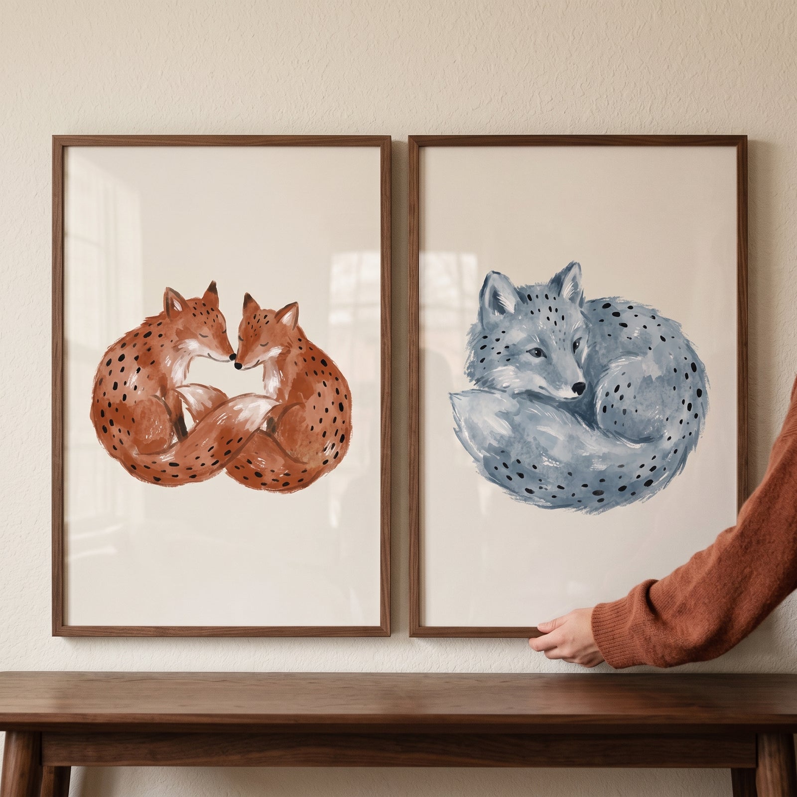Spotted watercolor fox wall art set of 2 features two curled red foxes and one blue fox in matching wooden frames.