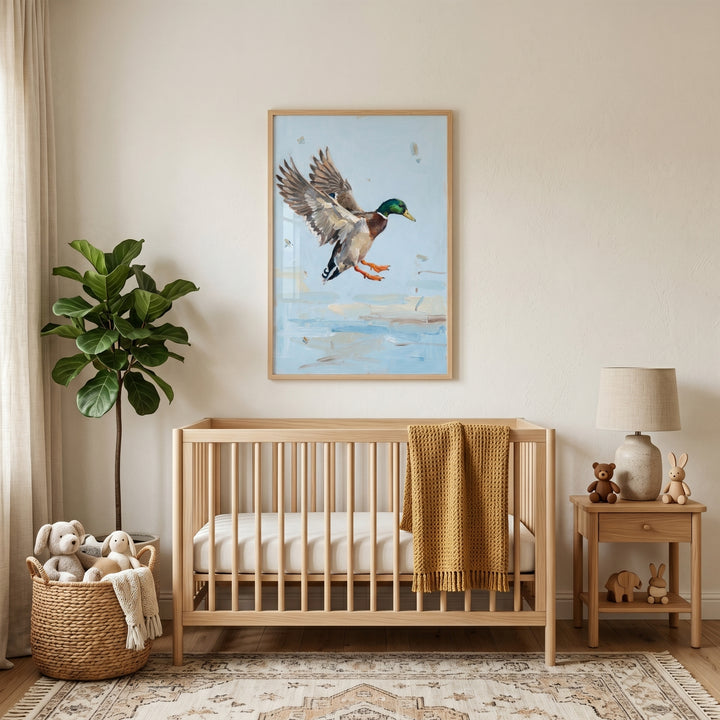 Wooden crib stands below spread wing landing mallard wall art in a neutral nursery with a potted plant and side table.
