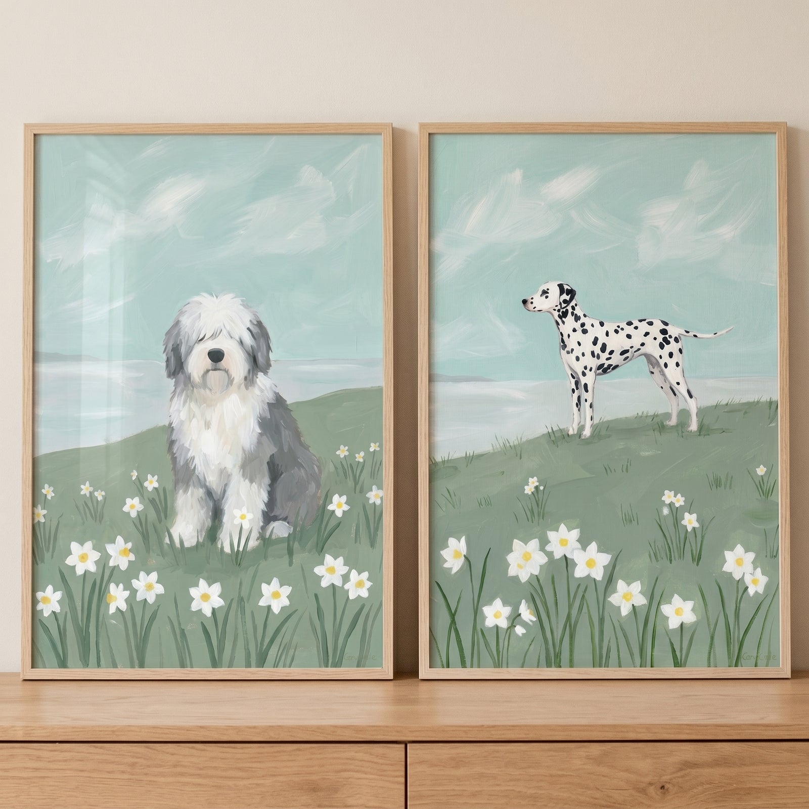 Springtime daffodil field dogs wall art set of 2 in wood frames with a sitting fluffy dog and a standing spotted dog.