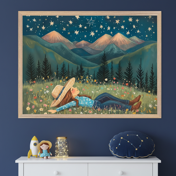 Kid's bedroom with a dark blue wall and white dresser. A large framed painting hangs above the dresser, depicting a girl lying in a field of wildflowers under a starry night sky with mountains. A rocket toy, doll, and constellation pillow are on the dresser.