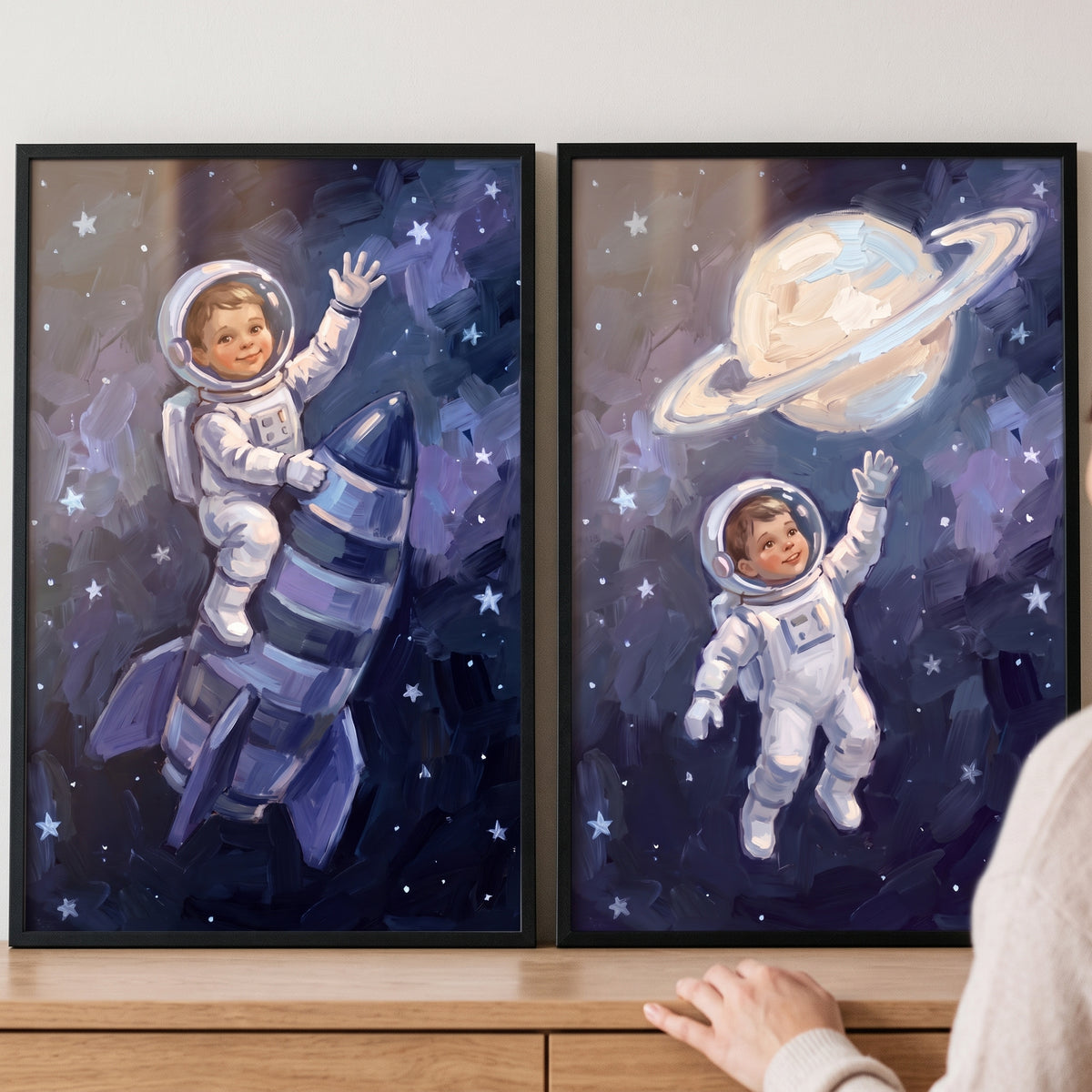 Starlit sapphire baby astronaut wall art set of 2 shows a child on a rocket and reaching for a ringed planet.