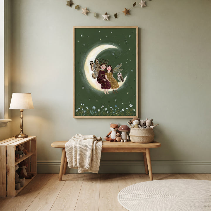 Starry crescent moon fairies wall art hangs in a nursery room above a wooden bench with stuffed animals and a lamp.