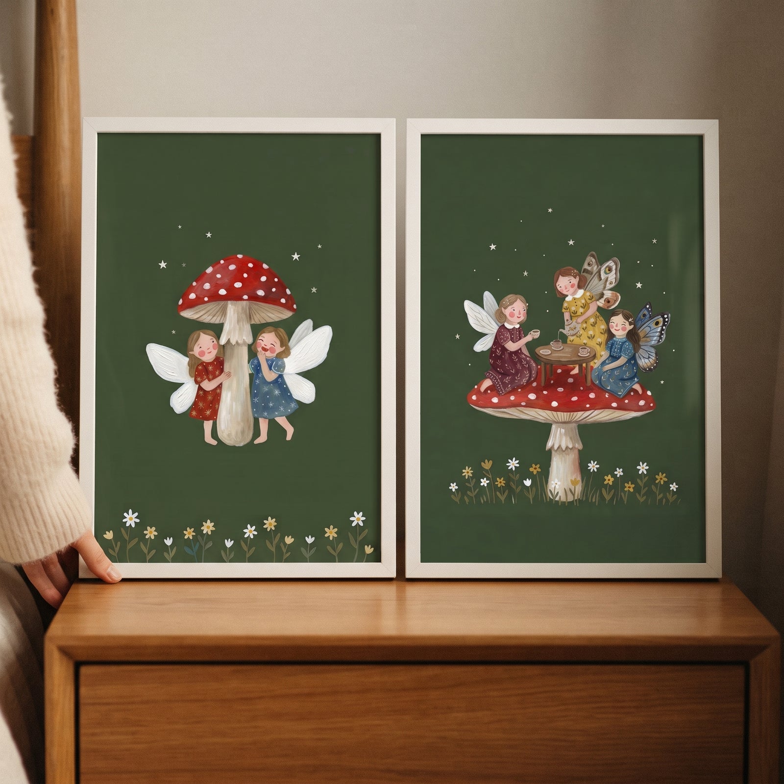 Starry dark forest fairies wall art set of 2 featuring fairies having tea and red mushrooms on a dark green background.