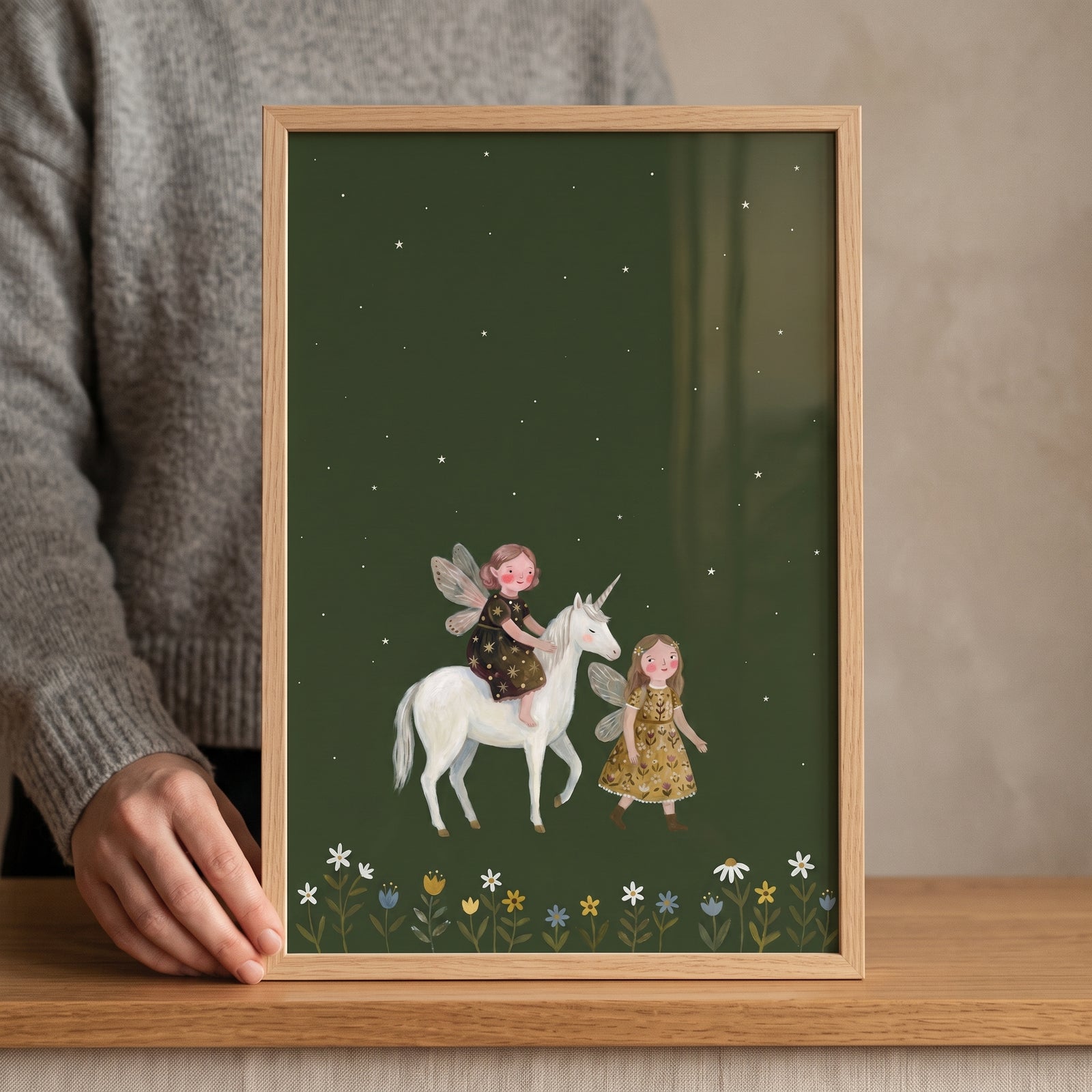 Framed starry forest unicorn fairies wall art showing two winged fairies and a white unicorn on a green background.