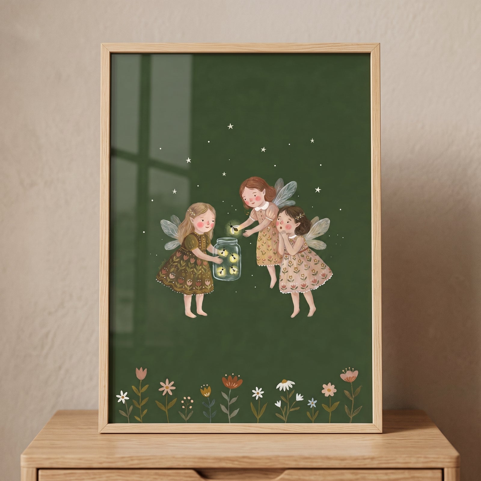 Starry night firefly fairies wall art shows three winged girls catching glowing bugs in a jar above a garden of flowers.