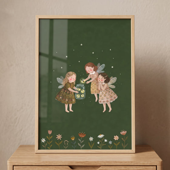 Starry night firefly fairies wall art shows three winged girls catching glowing bugs in a jar above a garden of flowers.