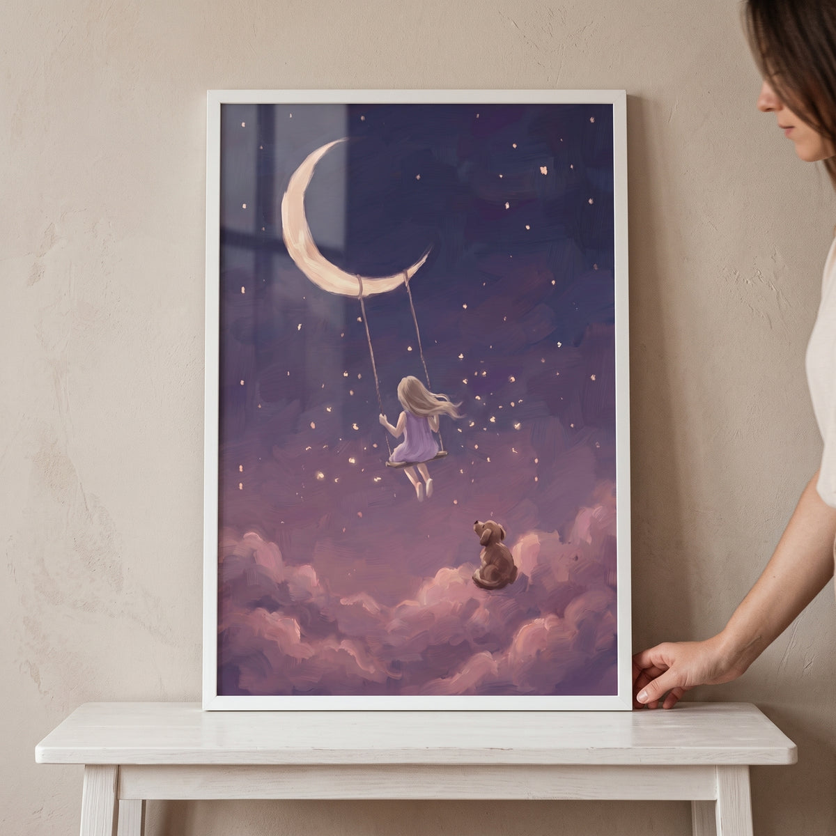 A girl on a swing hangs from a crescent moon over a dog on clouds in this starry night sky dog artwork.