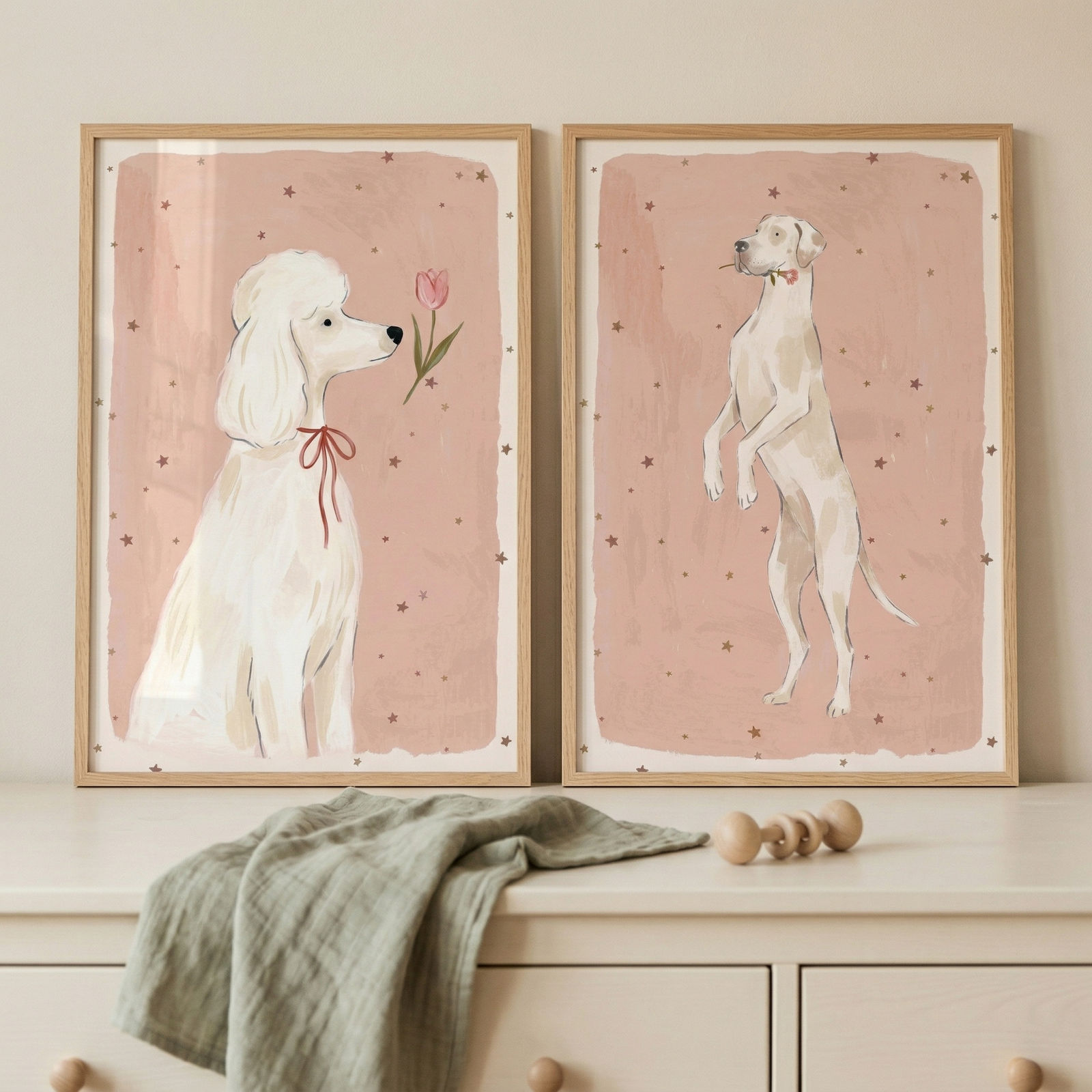 This image shows two matching wooden-framed illustrations of dogs resting on a light-colored dresser against a neutral wall.

The illustration on the left features a white dog with curly fur, similar to a poodle, sitting in profile and looking towards a single pink tulip. The dog is wearing a thin red ribbon tied in a bow around its neck. The artwork on the right depicts a tall, light-colored dog standing on its hind legs and facing towards the left. This dog has a simple red collar.
