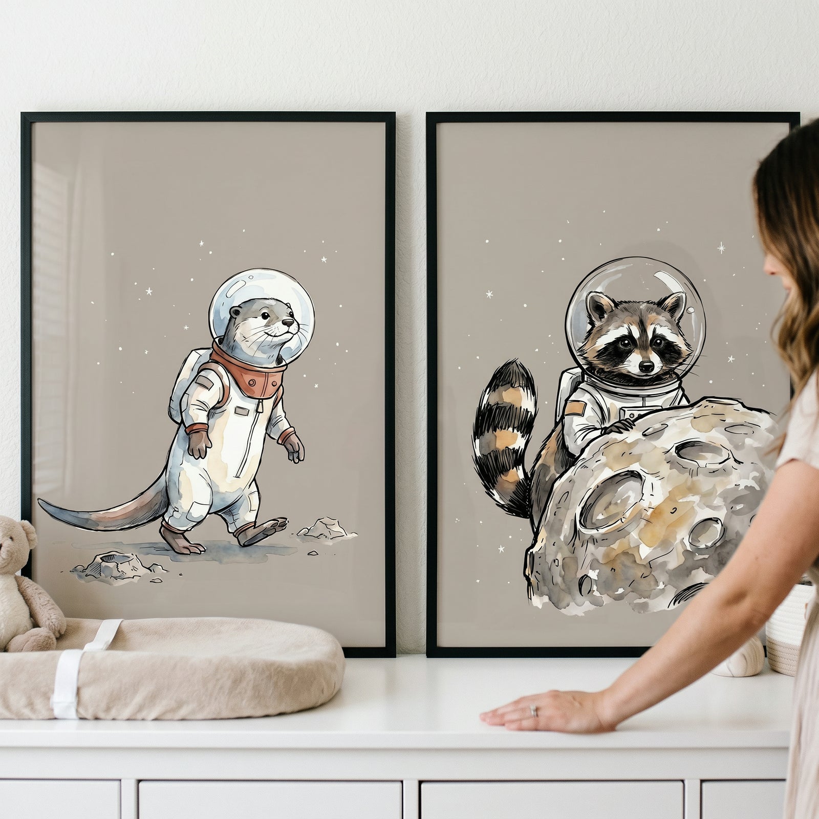 Starry sky astronaut animal wall art set of 2 featuring a cute otter and raccoon in space suits on lunar landscapes.