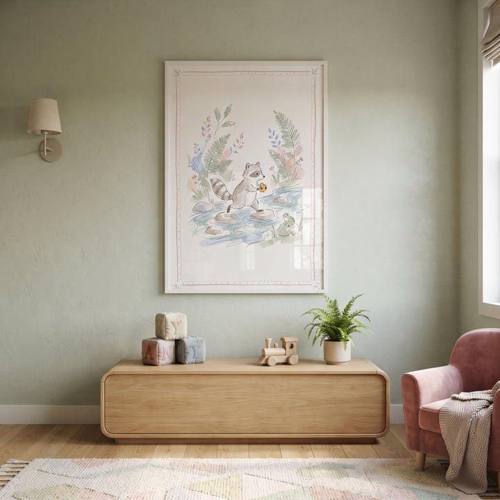 Stepping stone raccoon wall art hangs above a wooden console in a soft green nursery with a pink armchair and toys.