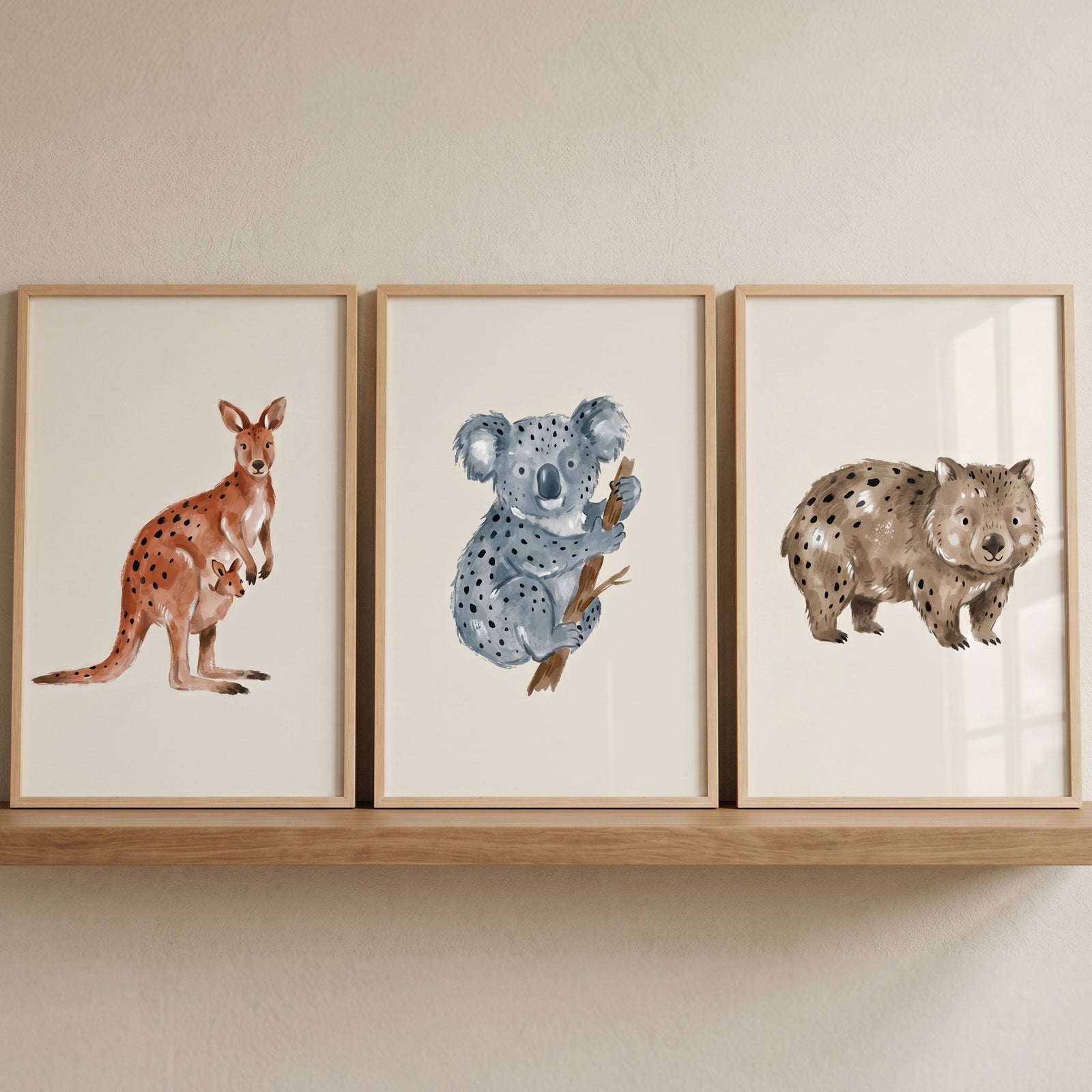 Stippled earthy australian wildlife wall art set of 3 featuring a kangaroo, koala, and wombat on a wooden shelf.