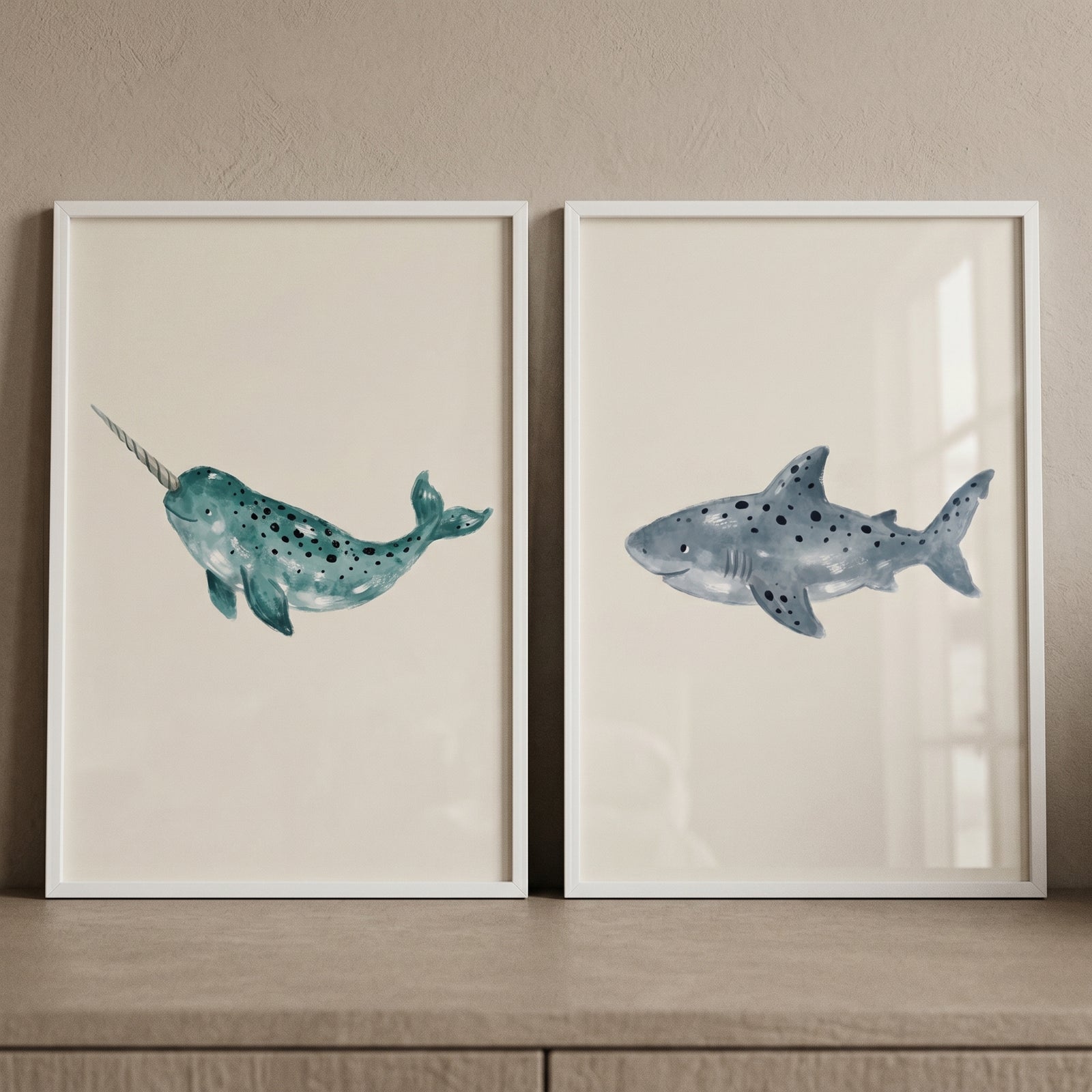 Stippled teal sea creature wall art set of 2 featuring a narwhal and a shark in white frames.