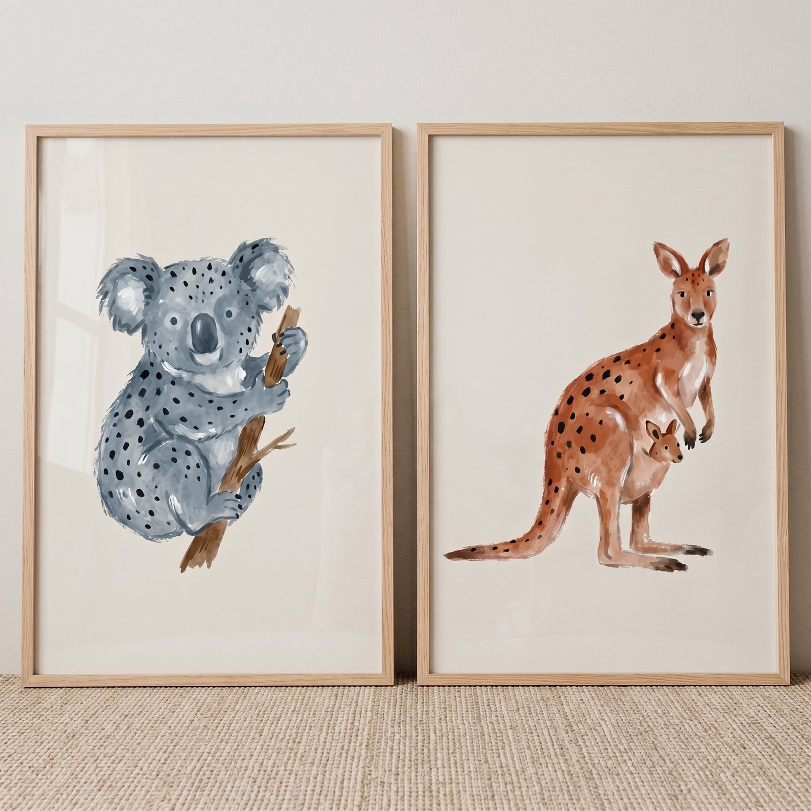 Stippled watercolor australian animal wall art set of 2 with a gray koala on a branch and a brown kangaroo with a joey.