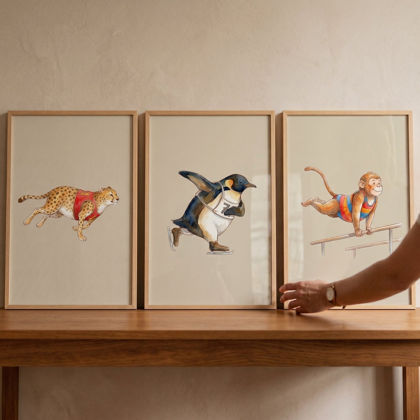 Storybook watercolor sports animals wall art set of 3 featuring a cheetah, penguin, and monkey on a wooden table.