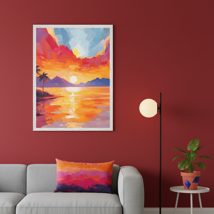 Modern living room with a gray sofa against a deep red wall. A framed impressionistic painting of a tropical sunset over water with mountains and a palm tree hangs above the sofa. A floor lamp and small side table with a potted plant are to the right. A colorful cushion is on the sofa.