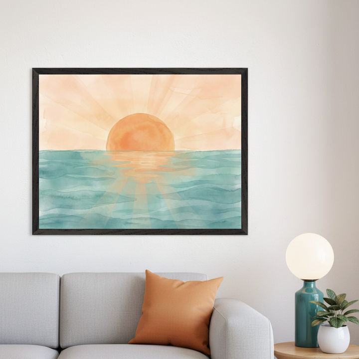 Modern living room with a grey sofa and orange cushion. A large framed watercolor of an orange sun reflecting over blue-green ocean waves hangs above the sofa. A lamp and plant sit on a side table.