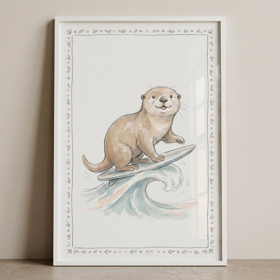 Framed surfing otter wall art shows a brown otter on a surfboard riding a wave within a decorative leaf border.