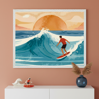 Modern room with a terracotta wall and white dresser. A large white-framed illustration of a surfer on a big blue wave with a setting orange sun hangs above. On the dresser, a white wave sculpture, a surfer cutout, and a blue vase with pampas grass.