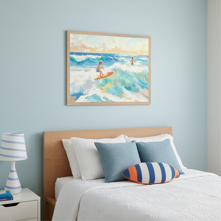 Kid's bedroom with a light wood bed, white bedding, and blue accent pillows. A white nightstand with a striped lamp is to the left. Above the bed hangs a framed painting of two boys surfing on blue waves under a bright sky in a painterly style.