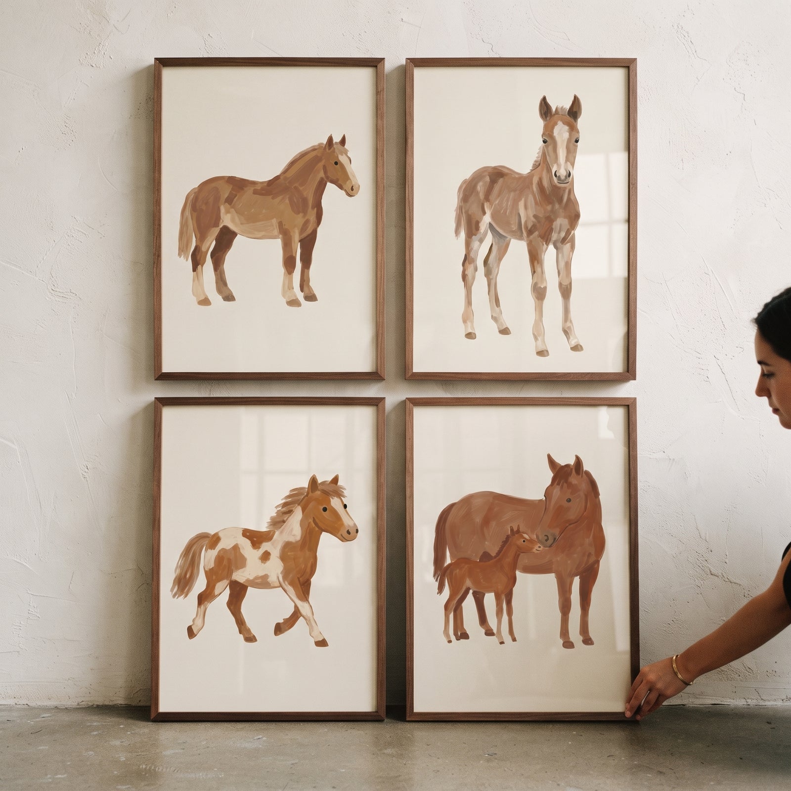Tan horse wall art set of 4 featuring various brown horses and foals in wood frames on a textured white wall.