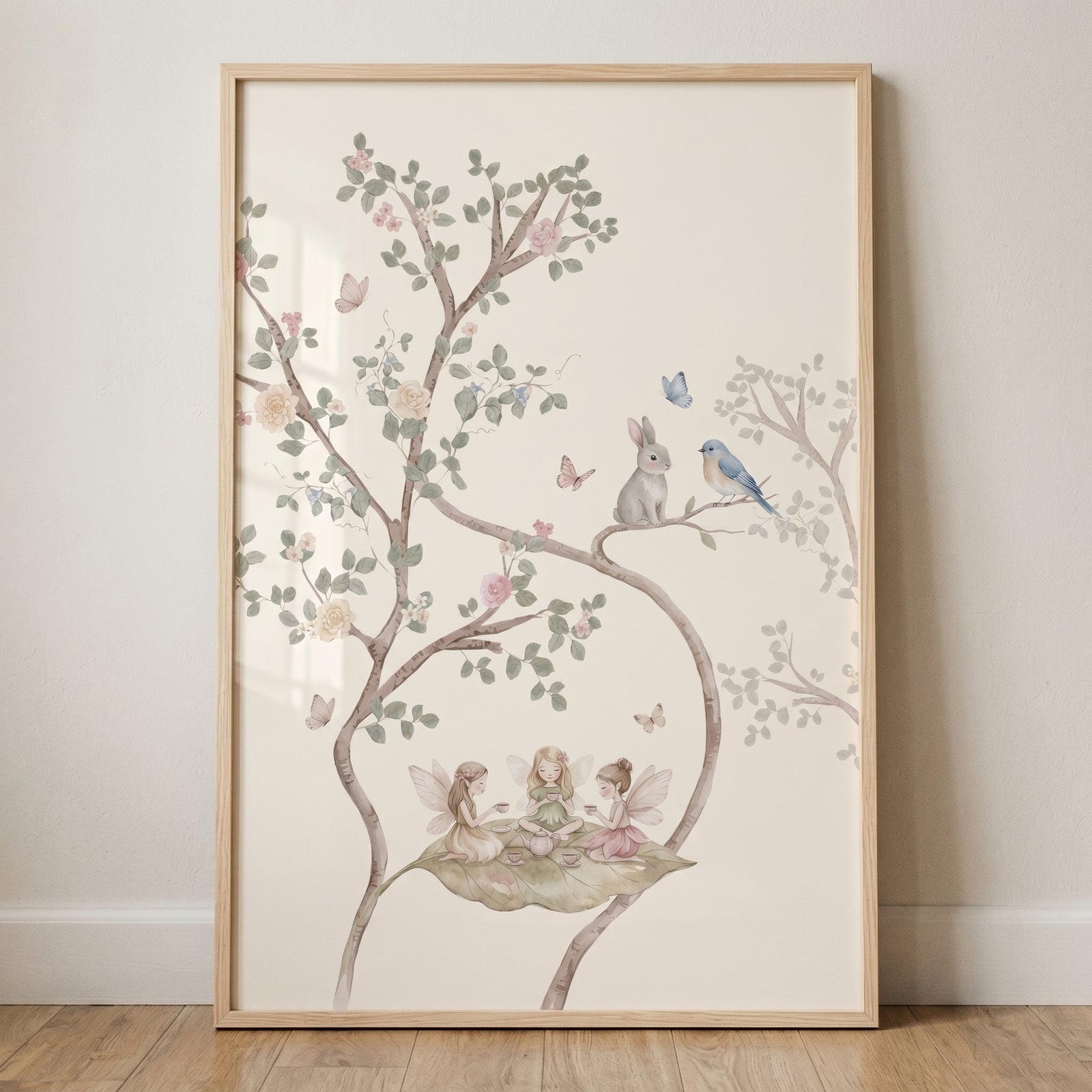 Framed tea party woodland fairies wall art shows three fairies on a leaf, a rabbit, and a bird among flowering branches.