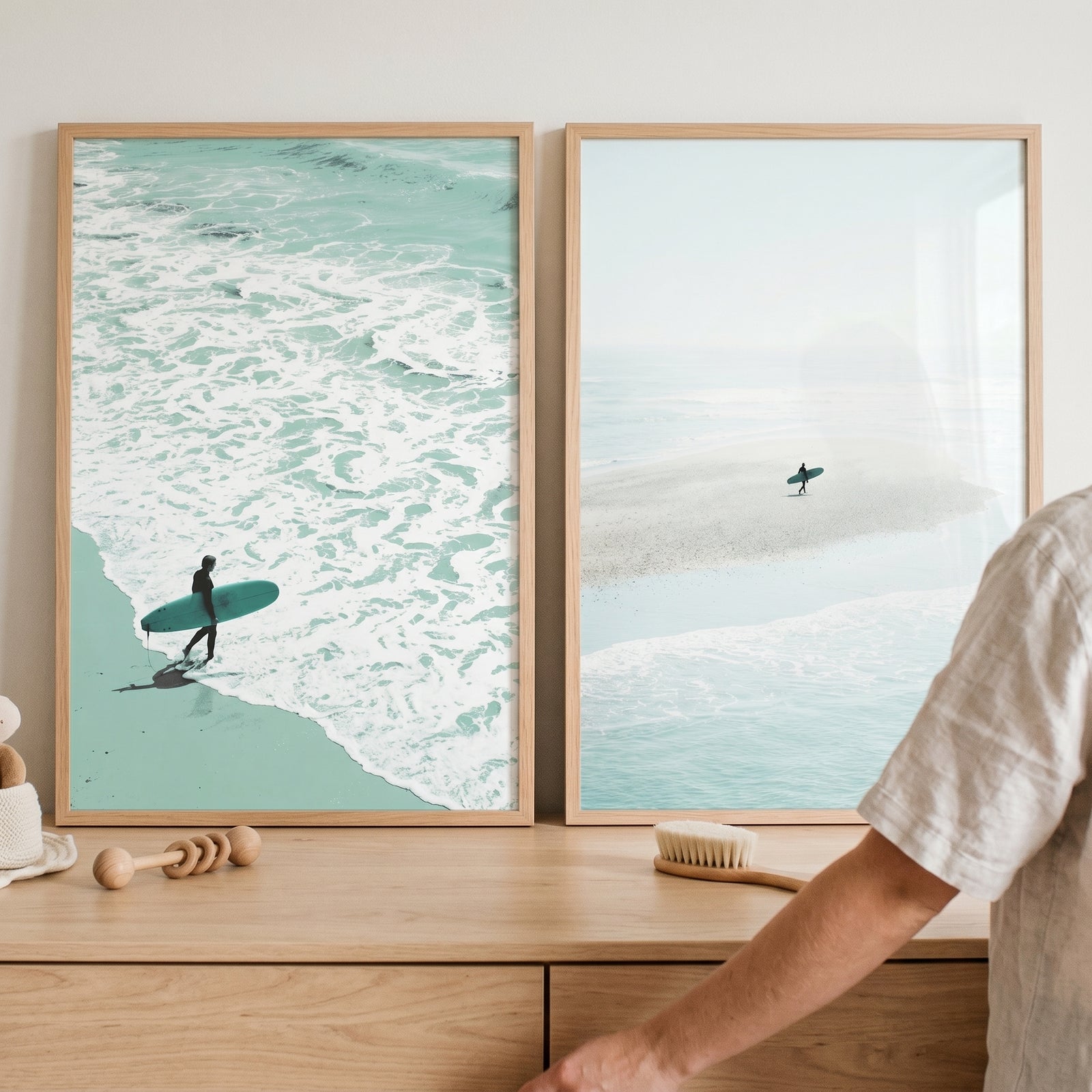 Teal coastal minimalist surfer wall art set of 2 in wooden frames shows surfers walking through waves and on a sandbar.