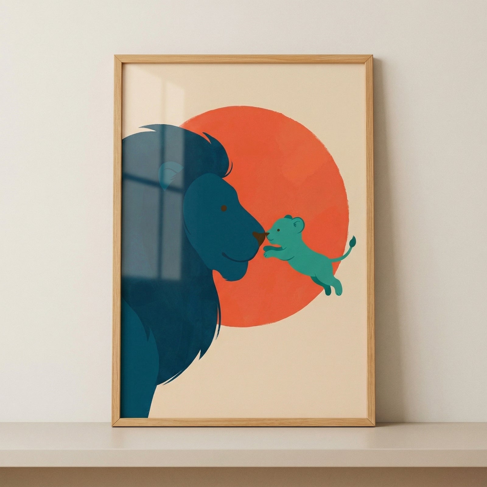 Framed illustration of a blue lion and a playful cub reaching toward each other in front of a bold red sun. The simple warm design stands out as a cheerful focal point for a nursery or child’s room.