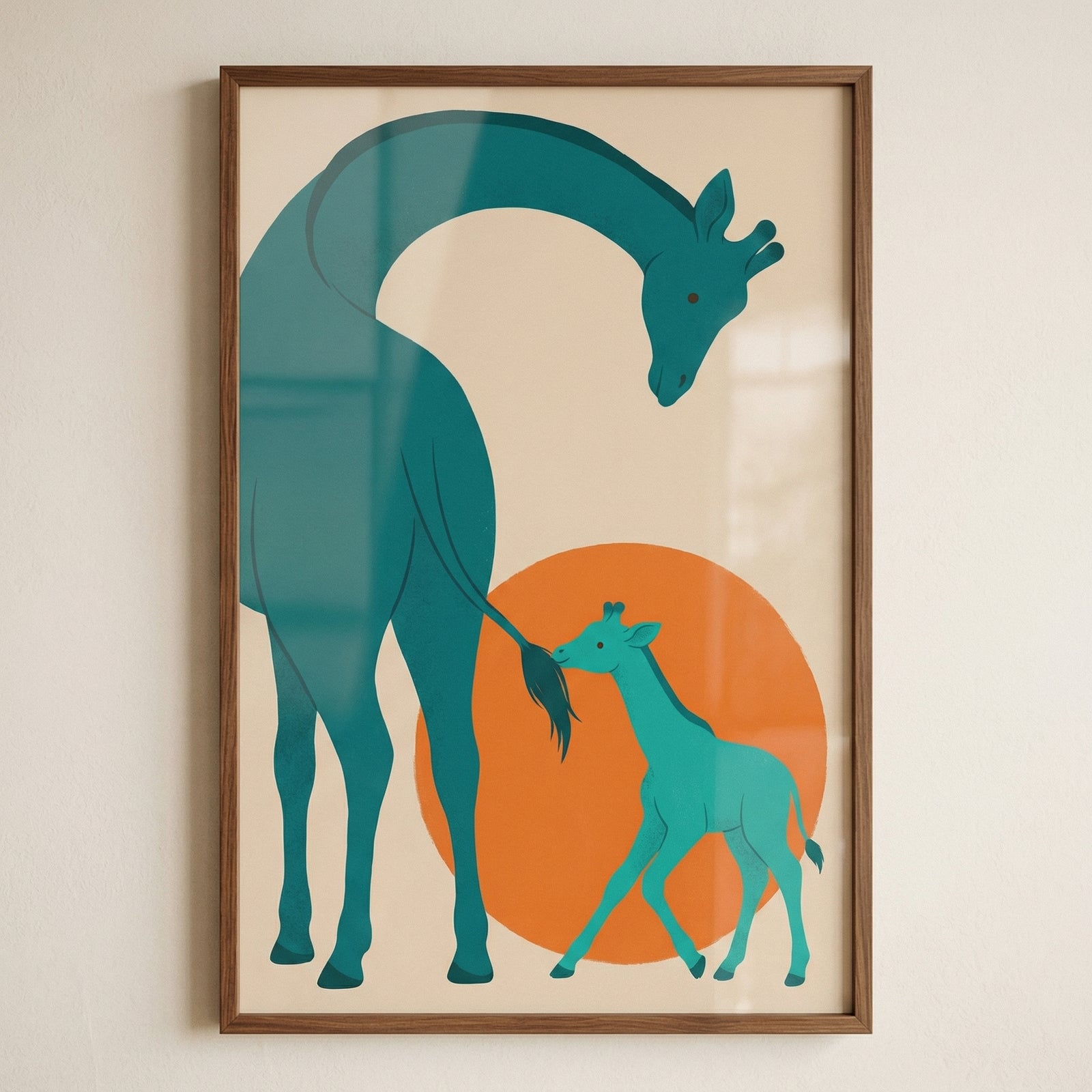A minimalist framed piece of art hanging on a light-colored wall. The art features a stylized illustration of two giraffes against a neutral cream background. A large adult giraffe, rendered in a dark teal hue, has its long neck elegantly curved over a smaller, bright turquoise calf. The calf is positioned in front of a large, solid orange circle that resembles a sun. The design uses flat colors and simple, clean lines in a modern graphic style. The art is enclosed in a thin, dark brown wooden frame.