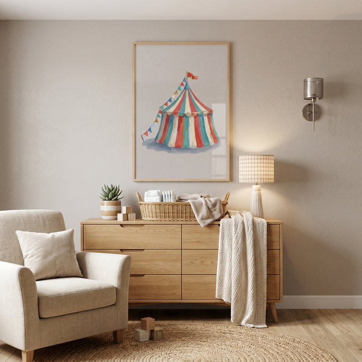Teal red circus tent wall art hangs above a wooden dresser and beige armchair in a neutral-toned room.