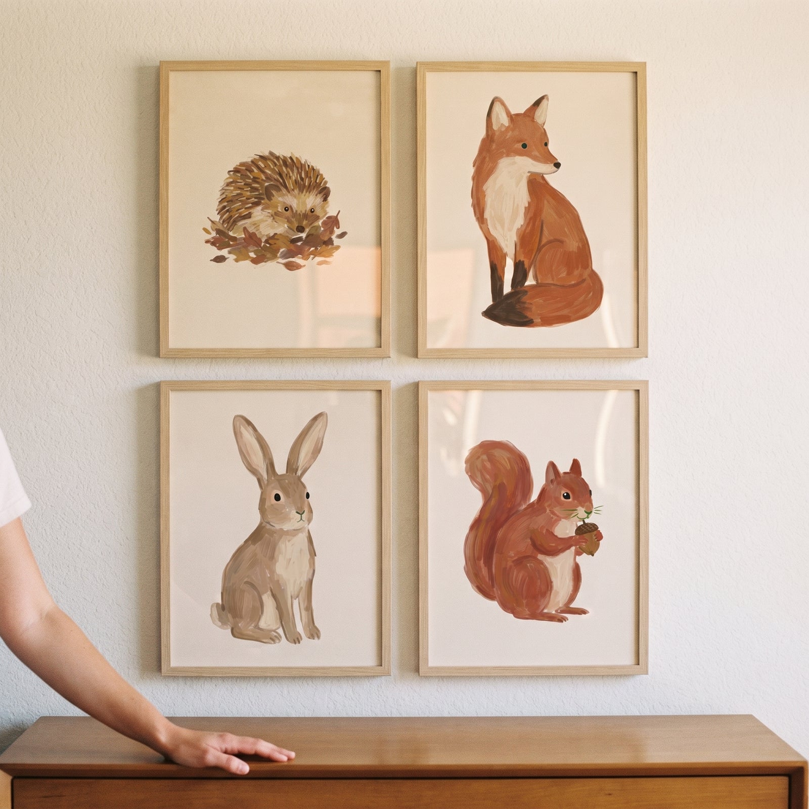 Terracotta tones woodland animals wall art set of 4 featuring a hedgehog, fox, rabbit, and squirrel in light wood frames.