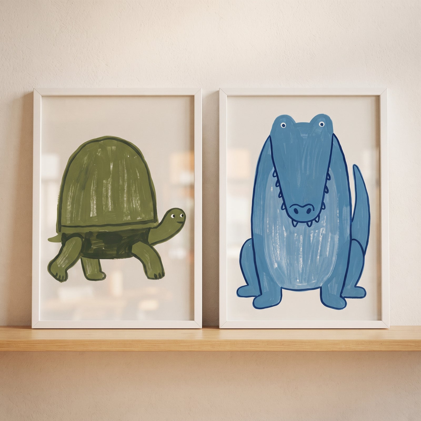 Textured blue green reptile animals wall art set of 2 features a cartoon turtle and crocodile in white frames on a shelf.
